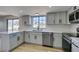 Spacious updated kitchen featuring stainless steel appliances, quartz countertops, and sleek grey cabinets at 3484 Nightflower Ln # B, Las Vegas, NV 89121
