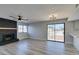 Cozy living room featuring a fireplace, wood-look floors, modern lighting, and sliding doors at 3484 Nightflower Ln # B, Las Vegas, NV 89121