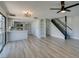 Spacious living area with open layout, a modern kitchen, a staircase, and sliding glass doors at 3484 Nightflower Ln # B, Las Vegas, NV 89121