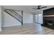 Living room showcasing a modern staircase, brick fireplace, and stylish design at 3484 Nightflower Ln # B, Las Vegas, NV 89121