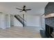 Living room showcasing a fireplace, a modern staircase, and built-in shelving at 3484 Nightflower Ln # B, Las Vegas, NV 89121