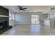 Bright living room features a fireplace, modern lighting, wood-look flooring, and sliding doors at 3484 Nightflower Ln # B, Las Vegas, NV 89121