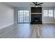 Spacious living area with modern flooring, a brick fireplace, and large sliding glass doors to the exterior at 3484 Nightflower Ln # B, Las Vegas, NV 89121