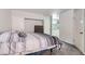 Bedroom featuring a bed with gray carpet, white doors, and neutral-toned decor, with a glimpse into the bathroom at 3609 Laguna Del Sol Dr, Las Vegas, NV 89121