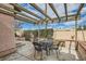 Cozy backyard patio with a pergola, outdoor seating, and privacy fencing, ideal for relaxation and entertainment at 3609 Laguna Del Sol Dr, Las Vegas, NV 89121