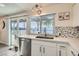 Kitchen featuring stainless steel appliances, white cabinets, and a view to the patio at 3665 Bronco Rd, Las Vegas, NV 89103