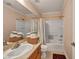 Clean bathroom featuring a vanity with modern faucet, shower over tub with curtain and tiled surround at 3724 Thomas Patrick Ave, North Las Vegas, NV 89032