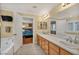 Well-lit bathroom boasts double sinks, a tub, and access to the bedroom at 3724 Thomas Patrick Ave, North Las Vegas, NV 89032