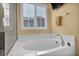Bathroom with a modern tub, shower with glass door, and natural light at 3724 Thomas Patrick Ave, North Las Vegas, NV 89032
