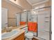 Bright bathroom featuring sink, shower with glass door, and orange towel at 3724 Thomas Patrick Ave, North Las Vegas, NV 89032