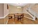 Dining room with decorative chandelier, panelled walls, and access to staircase and kitchen at 3724 Thomas Patrick Ave, North Las Vegas, NV 89032