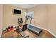 Home exercise room featuring tile floors, workout equipment, and a bright window at 3724 Thomas Patrick Ave, North Las Vegas, NV 89032