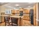 A spacious kitchen with ample cabinet space, tile floors, and a practical center island at 3724 Thomas Patrick Ave, North Las Vegas, NV 89032