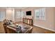 Spacious living room with tile floors, a brown leather couch, and a mounted TV at 3724 Thomas Patrick Ave, North Las Vegas, NV 89032