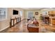 Open-concept living room with tile floors, a brown leather couch, and large windows at 3724 Thomas Patrick Ave, North Las Vegas, NV 89032