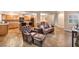 Open concept living room showcasing tile floors, stairs, and a kitchen with stainless steel appliances at 3724 Thomas Patrick Ave, North Las Vegas, NV 89032