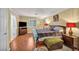 Spacious bedroom with a cozy bed, wood floors, walk-in closet, and ensuite bathroom at 3724 Thomas Patrick Ave, North Las Vegas, NV 89032