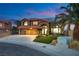 Two-story home with a three-car garage, stone accents, tile roof, and manicured lawn at 3924 Diamond Ridge St, Las Vegas, NV 89129