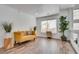 Bright living room with hardwood floors, large windows, yellow sofa and decorative plants at 3924 Diamond Ridge St, Las Vegas, NV 89129