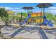 Brightly colored community playground featuring slides, climbing structures, and shaded seating areas at 4101 Akira Ave, North Las Vegas, NV 89084