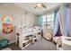 Bright bedroom with a loft bed, rainbow light, and playful decor near window at 421 Malpaso St, Las Vegas, NV 89138