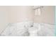 Bright bathroom featuring tiled walls, white toilet, and towel rack at 4381 W Flamingo Rd # 2322/2320, Las Vegas, NV 89103