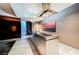 Modern kitchen island featuring sleek stainless steel finish, bar seating, and open living space at 4381 W Flamingo Rd # 2322/2320, Las Vegas, NV 89103