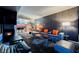Contemporary living room with gray sofa, vibrant orange pillows, fireplace, and open kitchen concept at 4381 W Flamingo Rd # 2322/2320, Las Vegas, NV 89103
