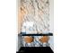 Modern bar area with marble wall, black countertop, and two brown leather bar stools at 4381 W Flamingo Rd # 5708, Las Vegas, NV 89103