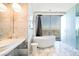 Luxury bathroom with soaking tub overlooking city views, marble accents, and double vanity at 4381 W Flamingo Rd # 5708, Las Vegas, NV 89103