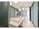 Sleek bathroom with double sinks, modern lighting, and glass enclosed shower at 4381 W Flamingo Rd # 5708, Las Vegas, NV 89103