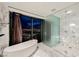 Modern bathroom featuring a soaking tub with city view and sleek glass-enclosed shower at 4381 W Flamingo Rd # 5708, Las Vegas, NV 89103