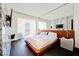 This bedroom features dark wood floors and a marble accent wall for a modern aesthetic at 4381 W Flamingo Rd # 5708, Las Vegas, NV 89103