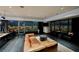 Modern living room features a leather sofa, sleek design, and panoramic city views through floor-to-ceiling windows at 4381 W Flamingo Rd # 5708, Las Vegas, NV 89103