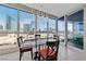 Modern dining room with glass table, seating for four, city view, and unique pendant lighting at 4525 Dean Martin Dr # 607, Las Vegas, NV 89103