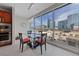 Bright dining area features a glass table set for four, a modern pendant light, and city views at 4525 Dean Martin Dr # 607, Las Vegas, NV 89103