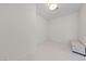 Bright, minimalist room with white walls, tile flooring and storage bench at 4525 Dean Martin Dr # 607, Las Vegas, NV 89103