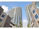 Low angle view of towering condo building with clean architectural lines against a blue sky with palm trees at 4525 Dean Martin Dr # 607, Las Vegas, NV 89103