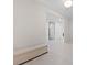 Hallway features white tile flooring, a sleek storage bench, and neutral color palette at 4525 Dean Martin Dr # 607, Las Vegas, NV 89103