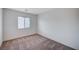 Empty bedroom featuring plush carpeting, a window with blinds, and neutral walls at 4907 Amberlyn St, Las Vegas, NV 89122