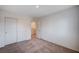 A carpeted bedroom with an ensuite bathroom, double door closet, and neutral walls at 4907 Amberlyn St, Las Vegas, NV 89122