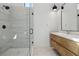 Modern bathroom featuring a glass shower and wood vanity at 500 Trenier Dr, Henderson, NV 89002