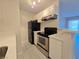 Close-up of a modern kitchen with stainless steel appliances and white cabinets at 5171 Lindell Rd # 107, Las Vegas, NV 89118