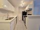 Modern kitchen featuring white cabinetry, stainless steel appliances, and a sleek countertop at 5171 Lindell Rd # 107, Las Vegas, NV 89118