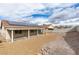 View of the backyard with a covered patio, low maintenance yard, and perimeter block wall at 523 Coolidge Ave, Henderson, NV 89015