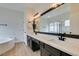 Spacious bathroom featuring double sinks, black cabinetry, and modern fixtures at 523 Coolidge Ave, Henderson, NV 89015