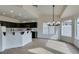 A spacious dining area with modern chandelier and natural light transitions into the kitchen at 523 Coolidge Ave, Henderson, NV 89015