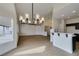 Open-concept living room featuring modern light fixture and light wood flooring at 523 Coolidge Ave, Henderson, NV 89015