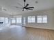 A bright living room with neutral walls, a modern ceiling fan, and beautiful wood-look floors at 523 Coolidge Ave, Henderson, NV 89015