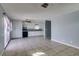 Open kitchen with tile floors, white cabinets, granite counters, and modern black appliances at 5239 Elgin Cir, Las Vegas, NV 89122